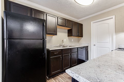 a kitchen with black appliances and granite counter tops